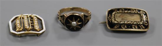 A George IV yellow metal and enamel mourning brooch, a 19th century childs? mourning ring and a yellow metal buckle,